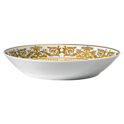 A white porcelain deep plate with gold floral motifs along the rim.