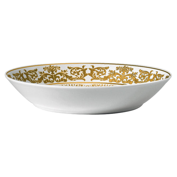 A white porcelain deep plate with gold floral motifs along the rim.