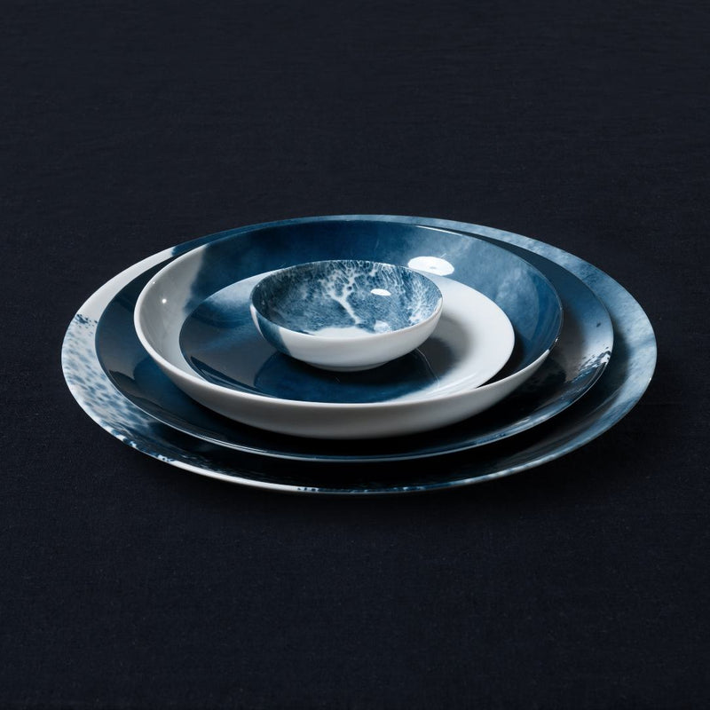 Set of blue and white plates Abysses collection Raynaud on a black background
