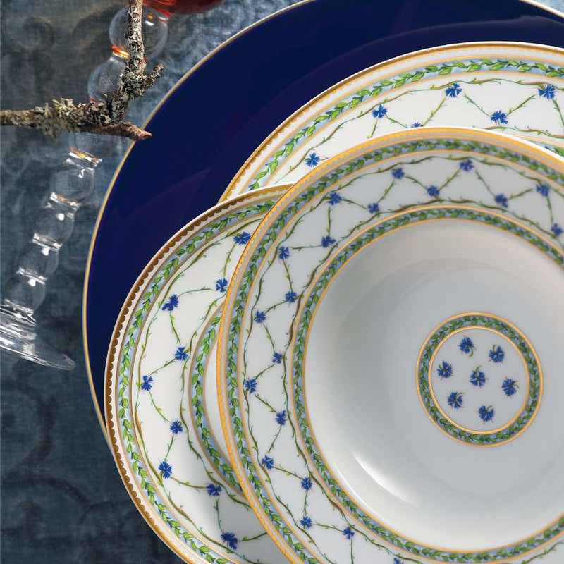 Set of decorative plates with floral patterns on a textured surface