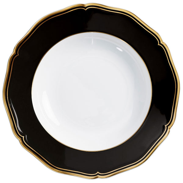 Porcelain deep plate with scalloped rim black border and gold edge from mazurka gold and black collection by raynaud on a white background