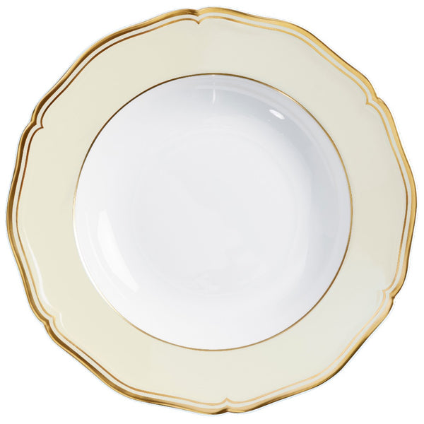 A round, ivory-colored Raynaud porcelain plate with gold accents and a decorative edge.