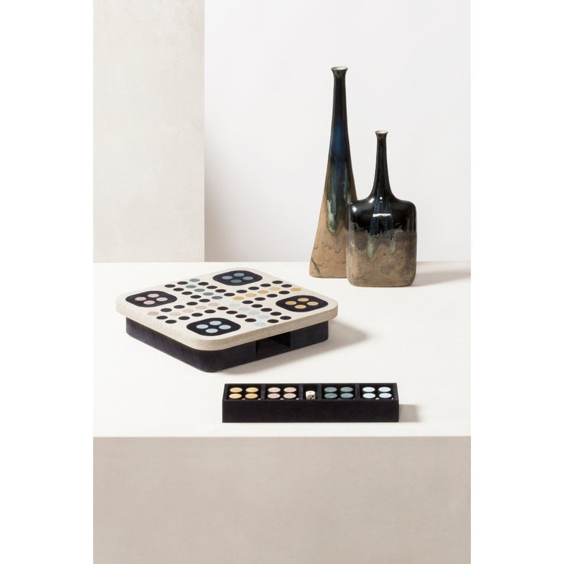 Decorative items including a Delos Ludo Game Set in marble and leather by Giobagnara and vases on a white surface.