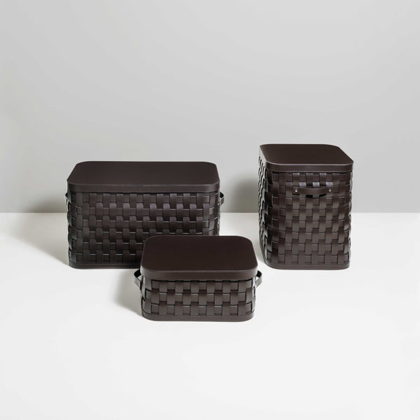 Three Demetra woven brown storage baskets of different sizes on a white surface with a light gray background.