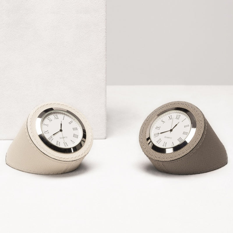 Two wedge-shaped clocks with white faces and silver bezels on a white background