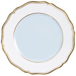 A porcelain dessert plate with a blue grey center and a gold border.