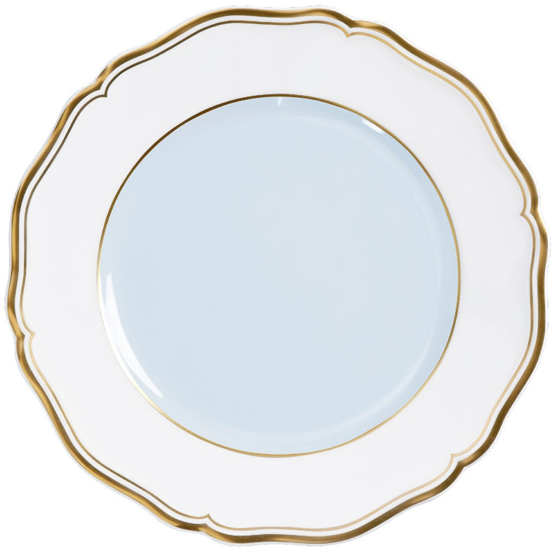 A porcelain dessert plate with a blue grey center and a gold border.