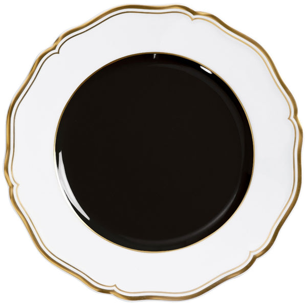 Porcelain dessert plate with black center scalloped rim and gold edge from mazurka gold and black by raynaud on a white background