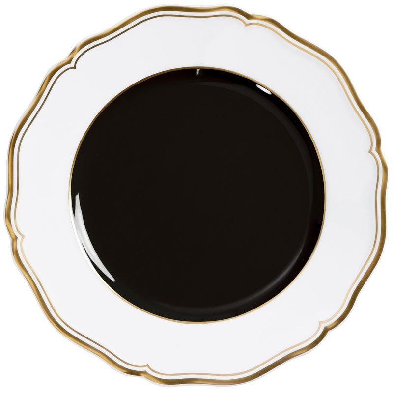 Porcelain dessert plate with black center scalloped rim and gold edge from mazurka gold and black by raynaud on a white background