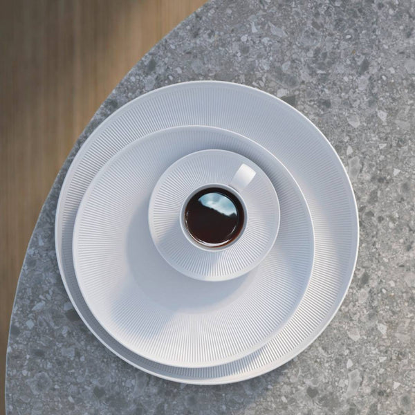White coffee filter with coffee inside on a gray stone surface