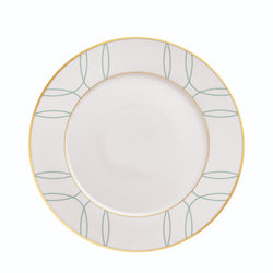 White plate with green leaf pattern and gold rim on a white background