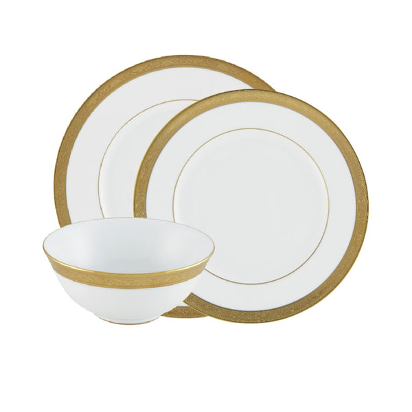 A set of white and gold porcelain dinnerware, including dinner plates, dessert plates, and soup bowls, with gold borders and rims.