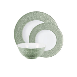 Dining set with green rimmed plates and bowl on a white background