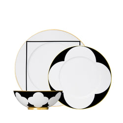 twelve piece porcelain dinnerware set from my china ca d oro collection in black white and gold by sieger furstenberg on a white background