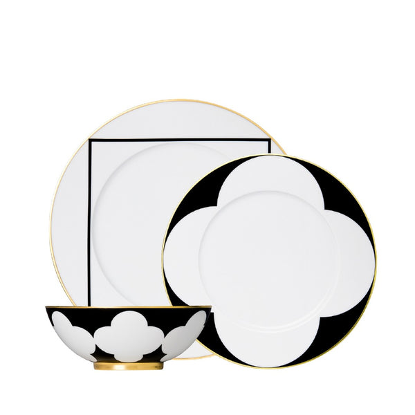 twelve piece porcelain dinnerware set from my china ca d oro collection in black white and gold by sieger furstenberg on a white background