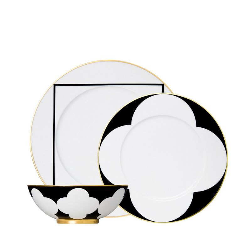 twelve piece porcelain dinnerware set from my china ca d oro collection in black white and gold by sieger furstenberg on a white background