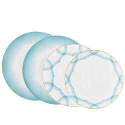 Aura dinnerware set of 16 pieces by Raynaud—Limoges porcelain with golden medallion and shaded blue line detailing.