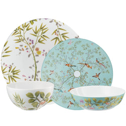 Set of porcelain dishes with nature-themed patterns on a white background