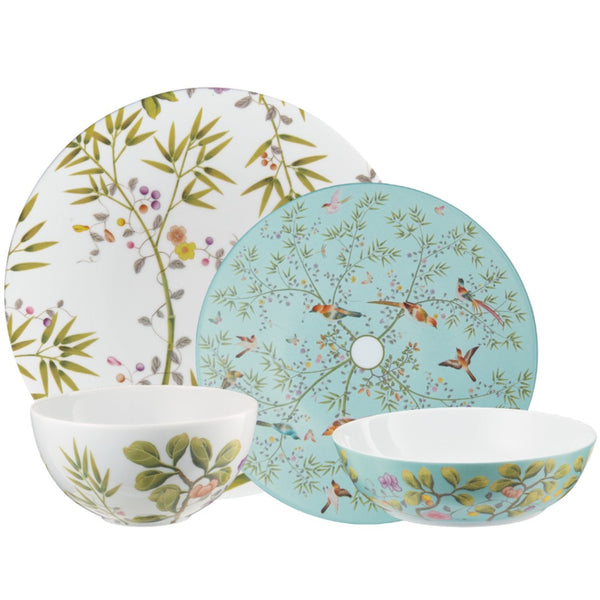 Set of porcelain dishes with nature-themed patterns on a white background