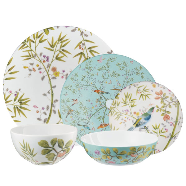 Set of porcelain plates and bowls with floral and nature-themed designs on a white background