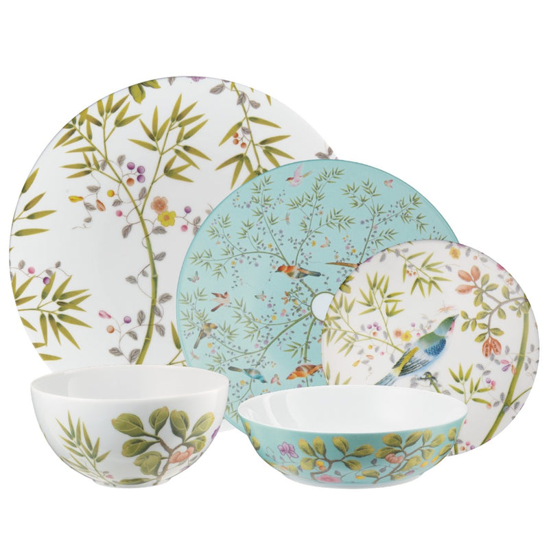 Set of porcelain plates and bowls with floral and nature-themed designs on a white background