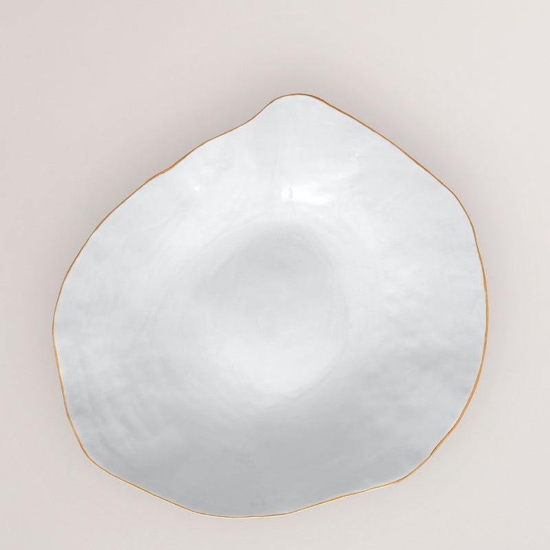 Decorative plate with gold frame on a light beige background