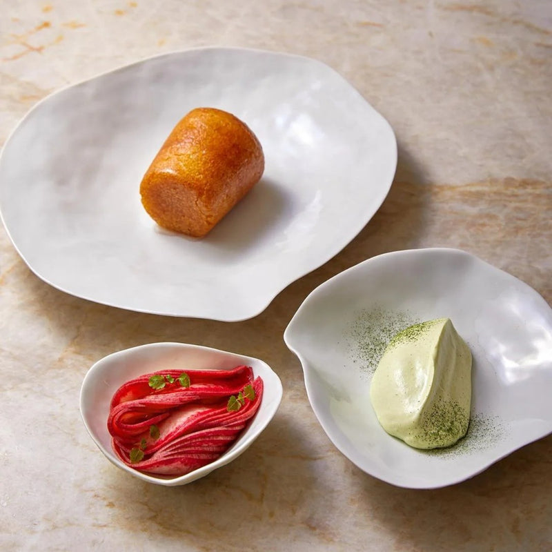 Luxury Limoges porcelain dinner set White Indulge collection Sarah-Linda containing different food items on a marble surface