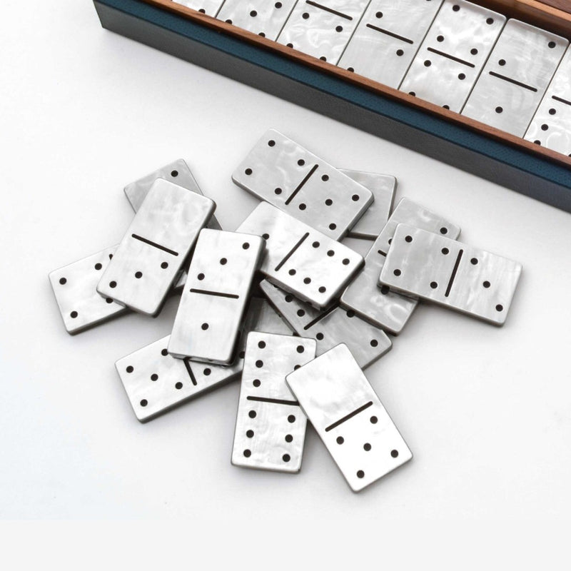 Domino pieces with a wooden box on a white background