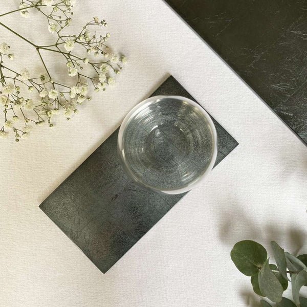 Clear glass bowl on a Double Silver Leaf coaster in Stormy Sky by Posh Trading Company, grey-blue lacquered base