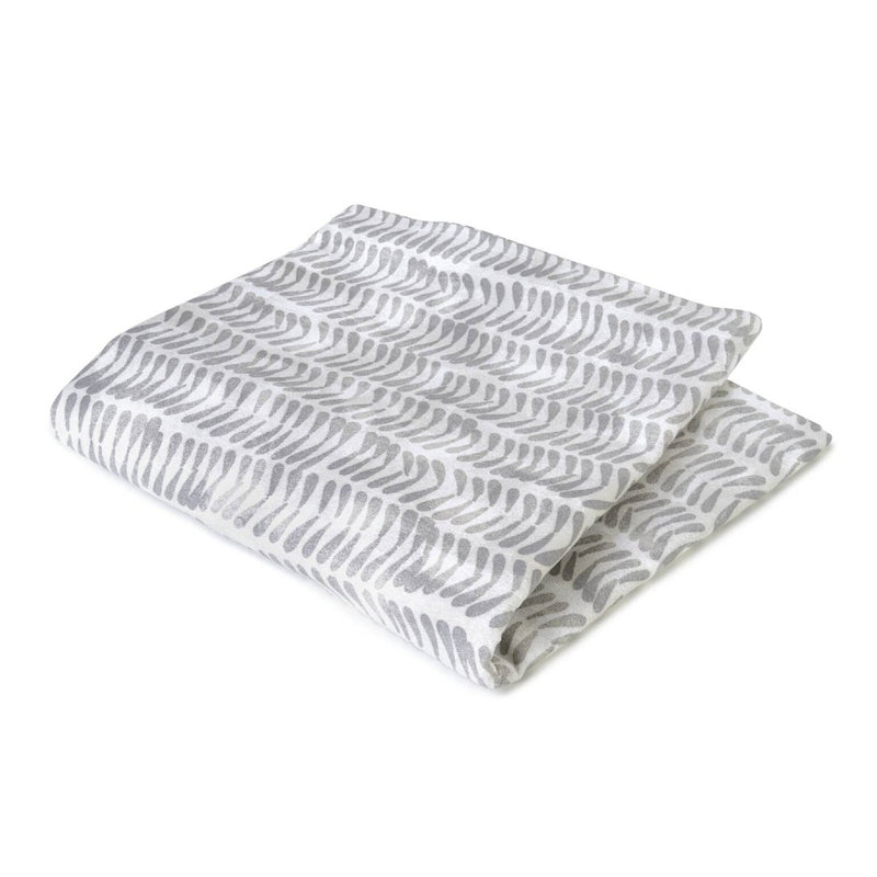 Folded fabric with wavy pattern on a white background