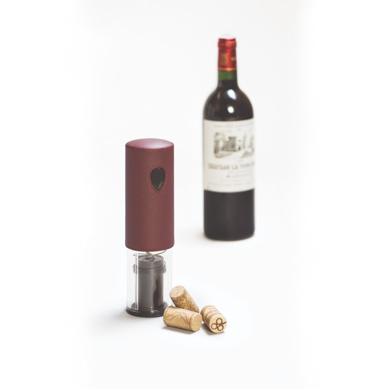 Wine bottle opener with corks next to a wine bottle on a white background