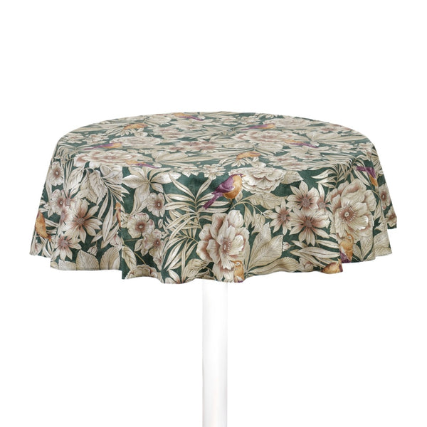 A round emerald green cotton tablecloth with a floral pattern featuring yellow-purple birds and beige flowers, displayed on a table with a white base.
