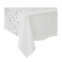 Alexandre Turpault Éole white linen tablecloth with small blue flowers styled on table with white background