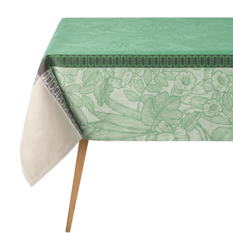 Green floral-patterned tablecloth on a table with white background