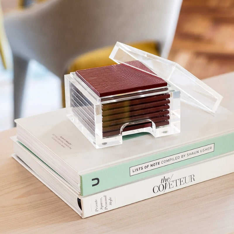 styled coffee table with books and Faux Python coasters set of 8 in burgundy with clear acrylic holder by Posh Trading Company