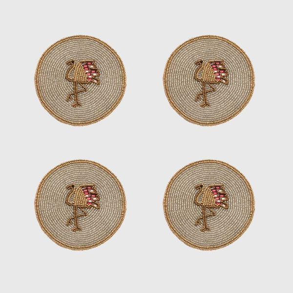 Four round beaded coasters with flamingo design on a light gray background
