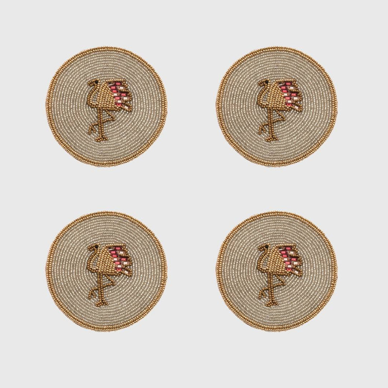 Four round beaded coasters with flamingo design on a light gray background