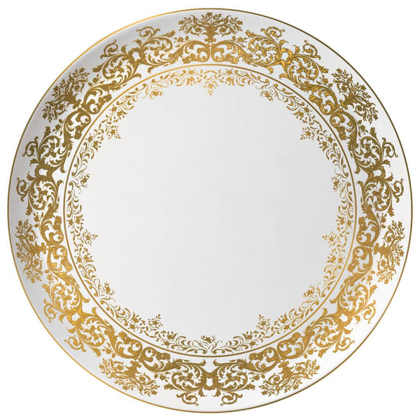 A white and gold porcelain cake serving plate with elaborate floral motifs and a scalloped edge.
