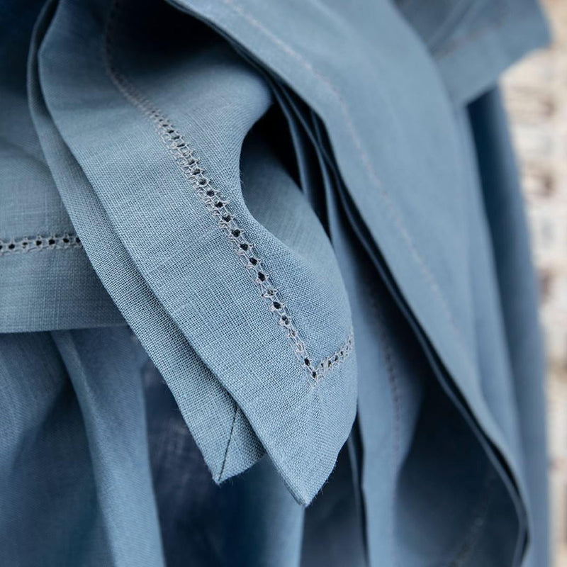 Close-up of blue fabric with intricate stitching detail