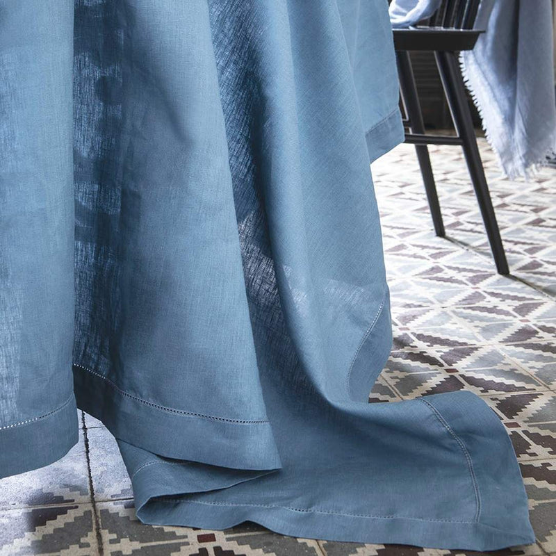 Blue tablecloth on a patterned floor