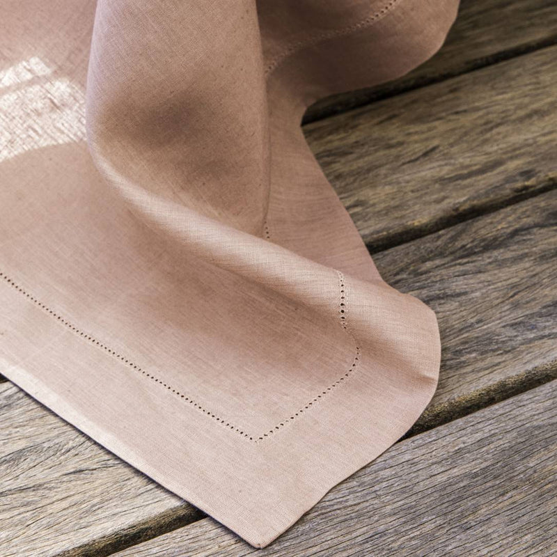 Folded pink napkin on a wooden surface