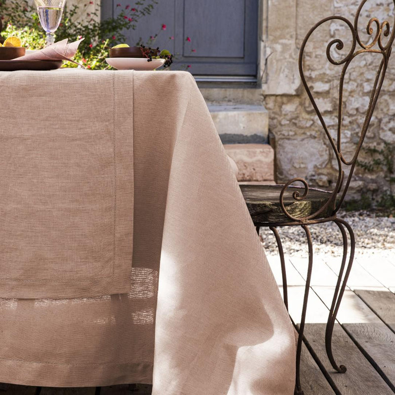 Pink tablecloth on a table with decorative elements in an outdoor setting.