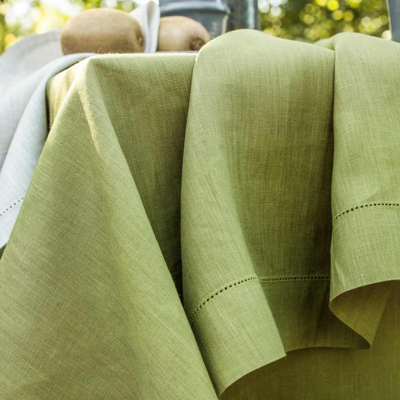 Close-up of green fabric with a blurred outdoor background