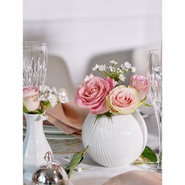 white round vase with pink roses