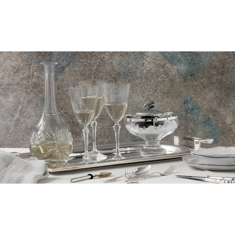 Elegant table setting with wine glasses, decanter, and Footed Caviar Bowl by Robbe & Berking on a marble surface.