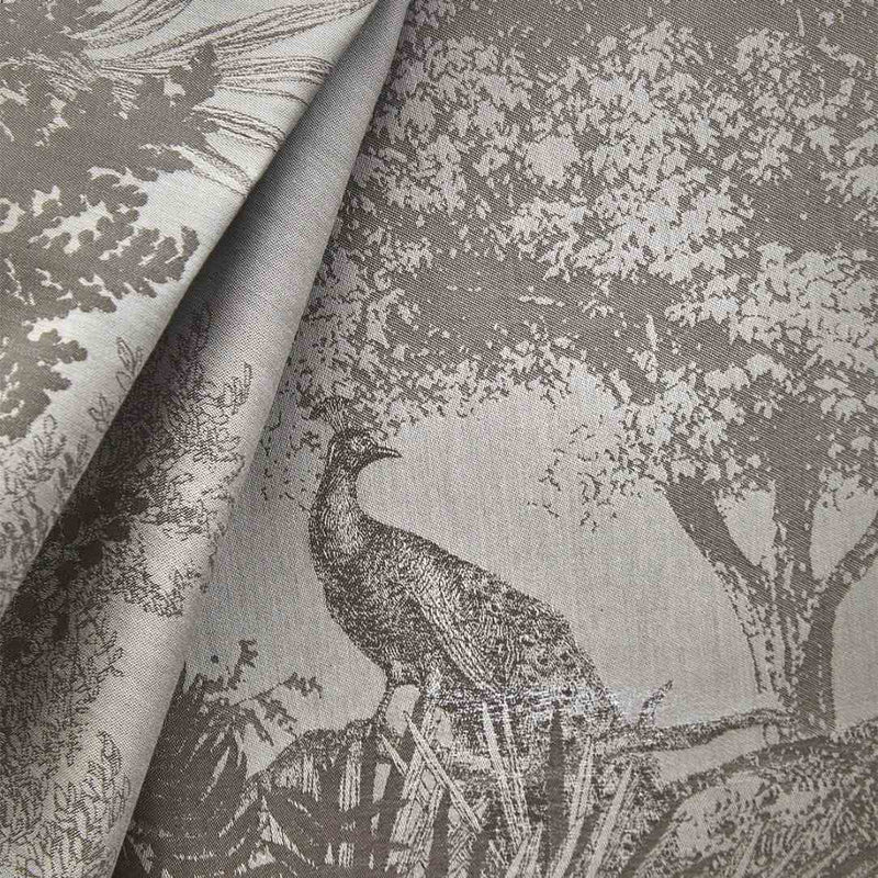 Fabric with a peacock and tree pattern in gray tones