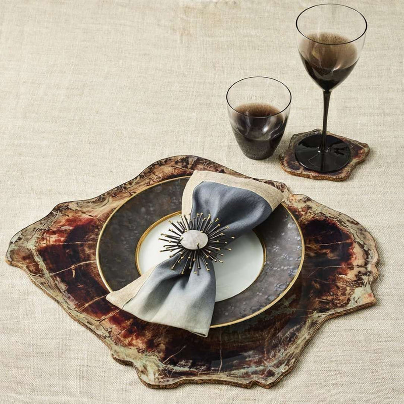 Decorative place setting with a napkin bow on a textured tablecloth.