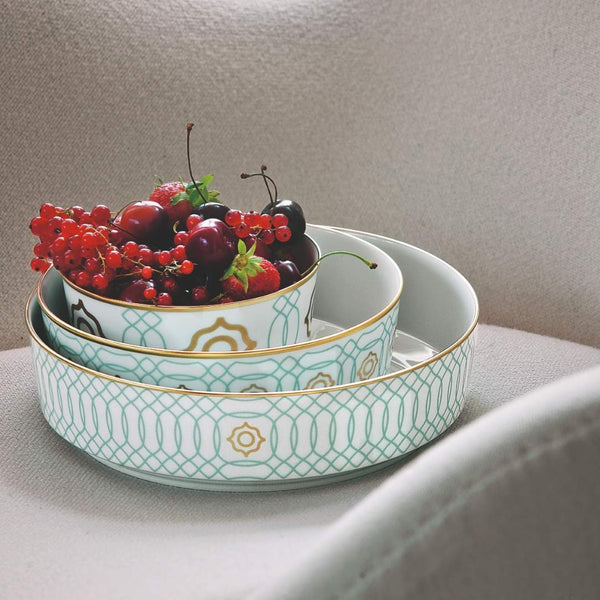Decorative porcelain bowls from Carlo Este collection with berries on a neutral background