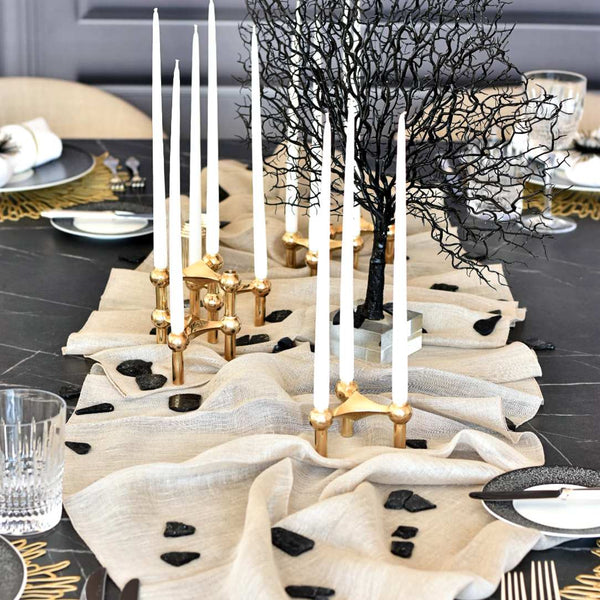 Lightweight Garza table runner in soft natural linen, casually draped on a modern table setting shown by Amiramour