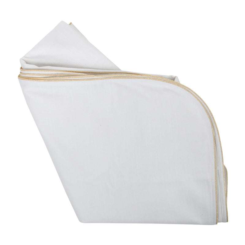 white tablecloth featuring a gold piping folded